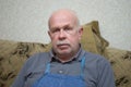 Portrait of a Caucasian senior man looking with pacification while sitting on a sofa