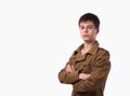 Portrait of caucasian teen boy on white background with folded arms. Royalty Free Stock Photo