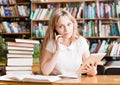 Portrait of a caucasian teen girl in library using tablet computer Royalty Free Stock Photo