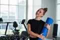 Portrait caucasian white woman smiling happily and holding a yoga mat and exercise ball Royalty Free Stock Photo