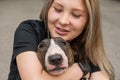 Portrait of caucasian woman hugging her bull terrier dog outdoors. Royalty Free Stock Photo