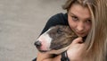 Portrait of caucasian woman hugging her bull terrier dog outdoors. Royalty Free Stock Photo