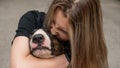 Portrait of caucasian woman hugging her bull terrier dog outdoors. Royalty Free Stock Photo