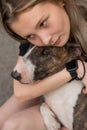 Portrait of caucasian woman hugging her bull terrier dog outdoors. Royalty Free Stock Photo