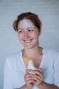 Portrait of a Caucasian woman with vitiligo diseas uses sunscreen