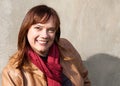 Portrait of a Caucasian Woman Wearing a Tan Leather Jacket and Red Scarf