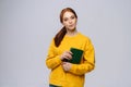 Portrait of caucasian young woman college student holding book and looking at camera Royalty Free Stock Photo