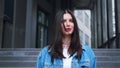 Portrait of caucasianwoman with brown hair shaking head outdoors urban city. Concept of emotions