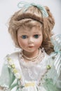 Ceramic porcelain blond doll in white dress Royalty Free Stock Photo