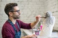 Portrait of Ceramist Dressed in an Apron Working on Clay Sculpture in Bright Ceramic Workshop. Royalty Free Stock Photo