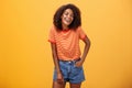 Portrait of charismatic charming african american stylish african american female in trendy shorts and t-shirt laughing