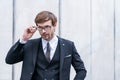 Portrait of charismatic young businessman in suit take off glasses Royalty Free Stock Photo