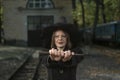 Portrait of charismatic young woman in a witch costume holds a Halloween party in front of her. School of Magic