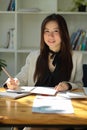 Portrait of a charming Asian businesswoman sitting at her office desk Royalty Free Stock Photo