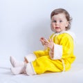 Portrait of charming baby in yellow baby rompers with hood
