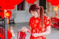 Portrait charming beautiful asian woman wear cheongsam dress up choose buy the incense, in the Chinese New Year. Royalty Free Stock Photo