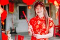 Portrait charming beautiful asian woman wear cheongsam dress up choose buy the incense, in the Chinese New Year. Festivities, Royalty Free Stock Photo