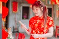 Portrait charming beautiful asian woman wear cheongsam dress up choose buy the incense, in the Chinese New Year. Festivities Royalty Free Stock Photo