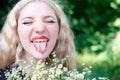 portrait of a charming blonde teenage girl wearing teeth braces with bouquet of white wildflowers. female with braces in Royalty Free Stock Photo