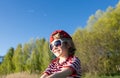 portrait of a charming boy 6 years old in a red striped t-shirt, big sunglasses emotionally joyfully laughing