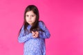 Portrait of a charming brunette little child girl, isolated on pink background Royalty Free Stock Photo