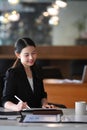 Charming businesswoman using digital tablet at her office desk. Royalty Free Stock Photo