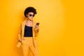 Portrait of charming cool afro american lady use her smartphone communicate with followers in blog type posts comments Royalty Free Stock Photo