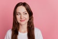 Portrait of charming cunning playful positive girl look empty space on pink background