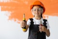 Portrait of a charming girl in an orange hard hat on her head. holds a screwdriver in his hands. goggles are worn over Royalty Free Stock Photo