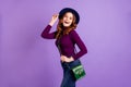 Portrait of charming girl touch hands fingers hat laugh isolated over purple violet background Royalty Free Stock Photo