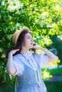 Girl in white dress near blooming apple tree Royalty Free Stock Photo