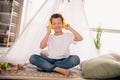 Portrait of charming happy small boy sitting floor listening music wear white shirt stylish child room interior Royalty Free Stock Photo