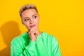 Portrait of charming intelligent girl arm touch chin look interested empty space isolated on yellow color background Royalty Free Stock Photo