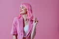 Portrait of a charming lady in a pink blazer pink wig cropped view pink background unaltered