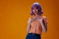 Portrait of a charming lady purple hair fashion posing glamor yellow background unaltered Royalty Free Stock Photo