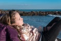 Portrait of a charming little blond girl lying on coastal stones Royalty Free Stock Photo