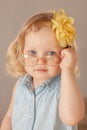 portrait charming little girl with beautiful blue eyes blonde in glasses in blue shirt t shirt Royalty Free Stock Photo