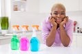 Portrait of charming lovely person arms touch cheeks three bottles cleaning detergent kitchen indoors