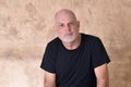 portrait of charming man in black shirt white beard and bald head