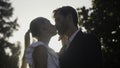 Portrait of charming man and woman newlyweds outdoors. Action. Happy wedding couple in summer garden. Cute bride and Royalty Free Stock Photo