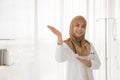 Portrait of charming muslim female doctor working at office and smiling at camera