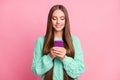 Portrait of charming person write comment hold device teal sweater outfit isolated on pink color background