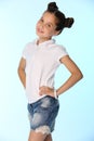 Portrait of a little girl 12 years old smiling, she is in a blue denim shorts