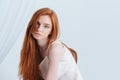 Portrait of a charming redhead woman looking at camera