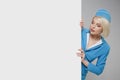 Portrait of charming stewardess wearing in blue uniform. Empty billboard Royalty Free Stock Photo