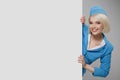 Portrait of charming stewardess wearing in blue uniform. Empty billboard Royalty Free Stock Photo