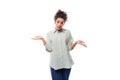 portrait of a charming sympathetic caucasian woman with black curly hair in a light shirt on a white background