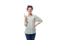 portrait of a charming sympathetic caucasian woman with black curly hair in a light shirt on a white background