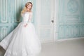 Portrait of charming woman in wedding dress. Dancing on the background walls with classic moldings Royalty Free Stock Photo