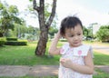 3 years old Asian little girl scratching her head Royalty Free Stock Photo